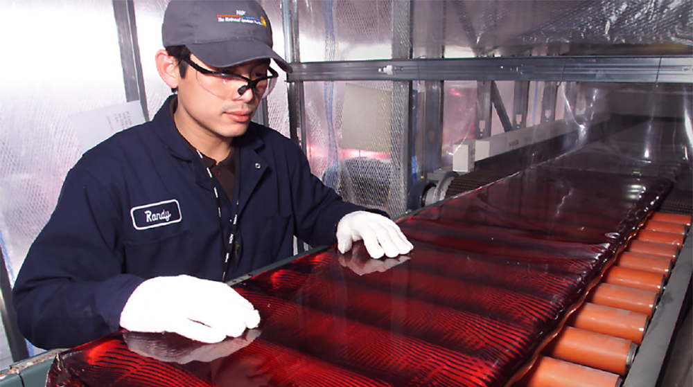 Technician Examines Continuous-Pour Laser Glass