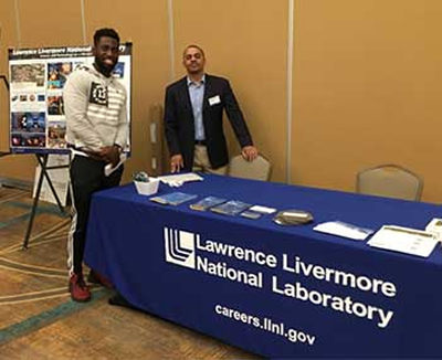 Ibo Matthews Mans LLNL Table at Black Physicists Conference
