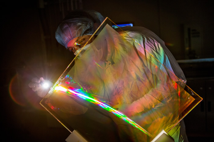 Researcher Inspects a Coated Grating Debris Shield