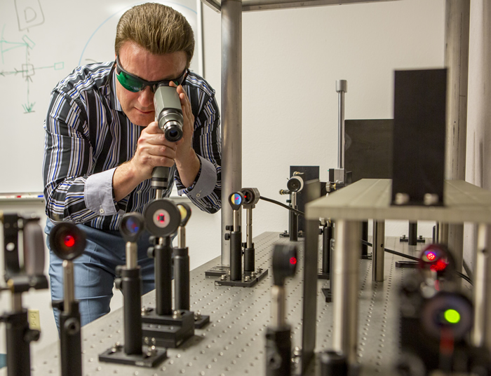 Jamie King Checks Equipment in the Laser Alignment Lab