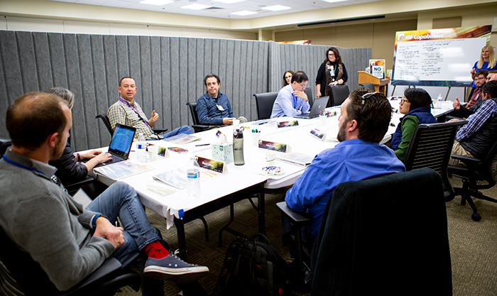 Photo of Idea Day attendees discussing ways to collaborate