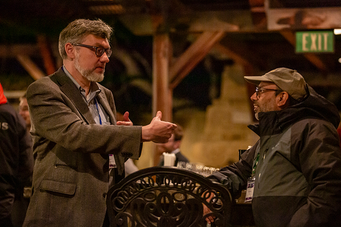 Photo of NIF Director Mark Herrmann chatting with Professor Farhat Beg of UC San Diego