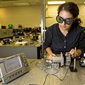 Photo of NIF physicist Leily Kiani testing optical fiber