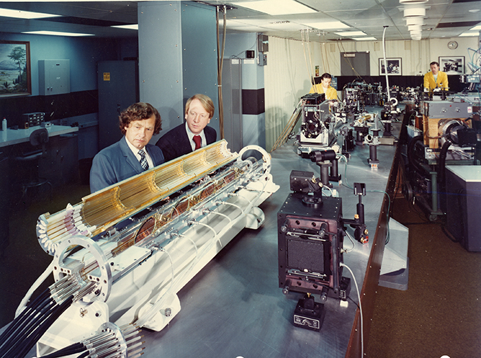Carl Haussmann and John Emmett work on lasers circa 1973