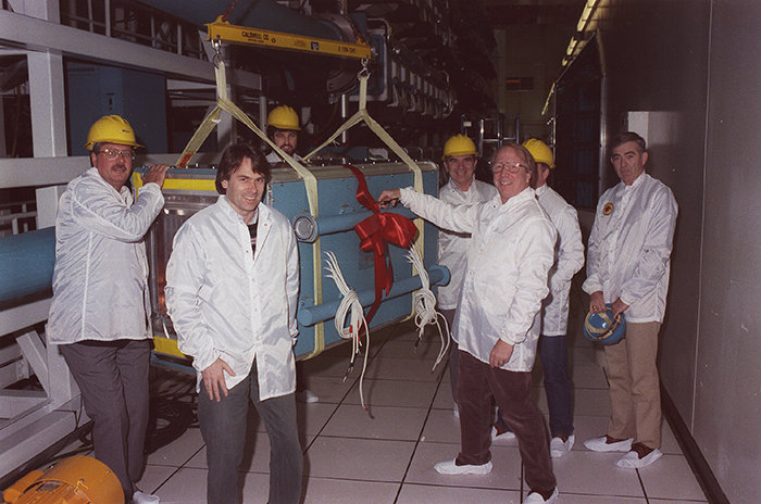 John Emmett, center, leader of LLNL’s first physics program, cuts the ribbon on the Nova laser