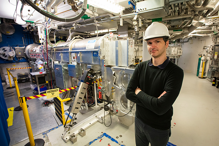 Lead scientist stands in front of the SLOS