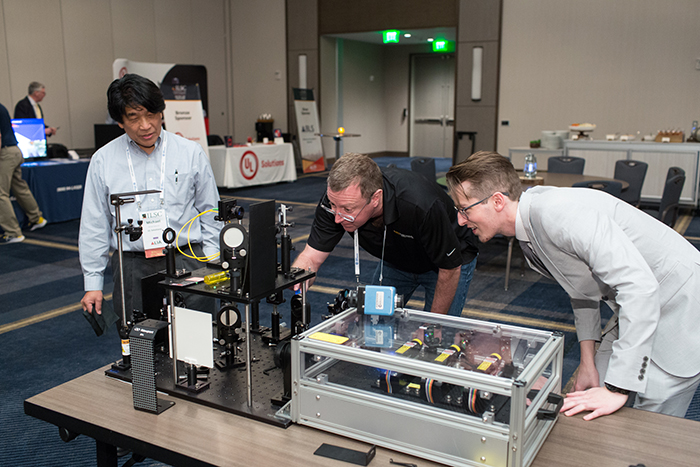 LLNL Deputy Laser Safety Officer Hayden Johnson shows the NIF&PS educational outreach 3-laser demo to fellow attendees at the 2023 International Laser Safety Conference